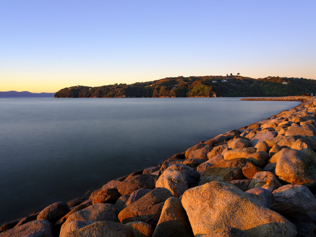New Zealand, Nelson & Marlborough, Marahau. Sunrise over Sandy Bay at Marahau - A gateway to the Abel Tasman National Park.