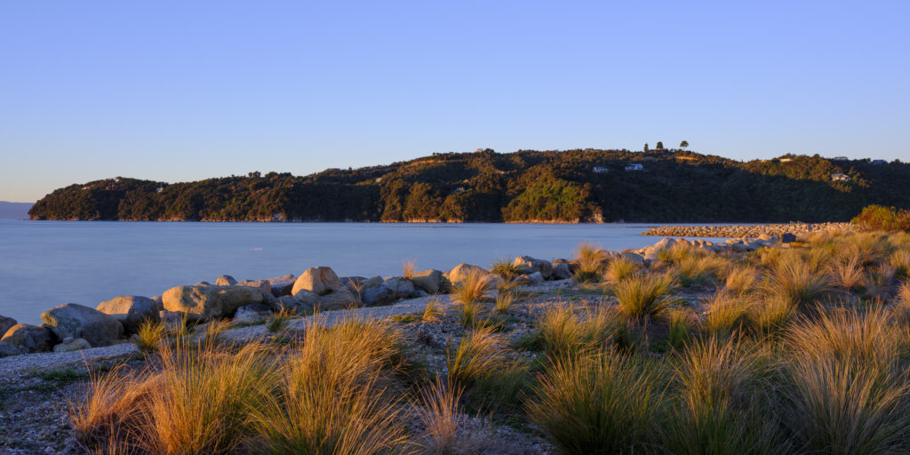 New Zealand, Nelson & Marlborough, Marahau. Sunrise over Sandy Bay at Marahau - A gateway to the Abel Tasman National Park.