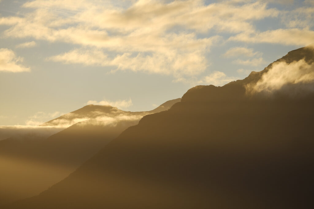 New Zealand, South Island, Fiordland National Park. Last light on the mountain peaks of the Fiordland National Park, viewed from the shores of Lake Te Anau.
