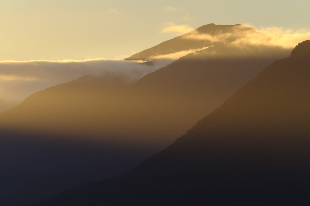 New Zealand, South Island, Fiordland National Park. Last light on the mountain peaks of the Fiordland National Park, viewed from the shores of Lake Te Anau.