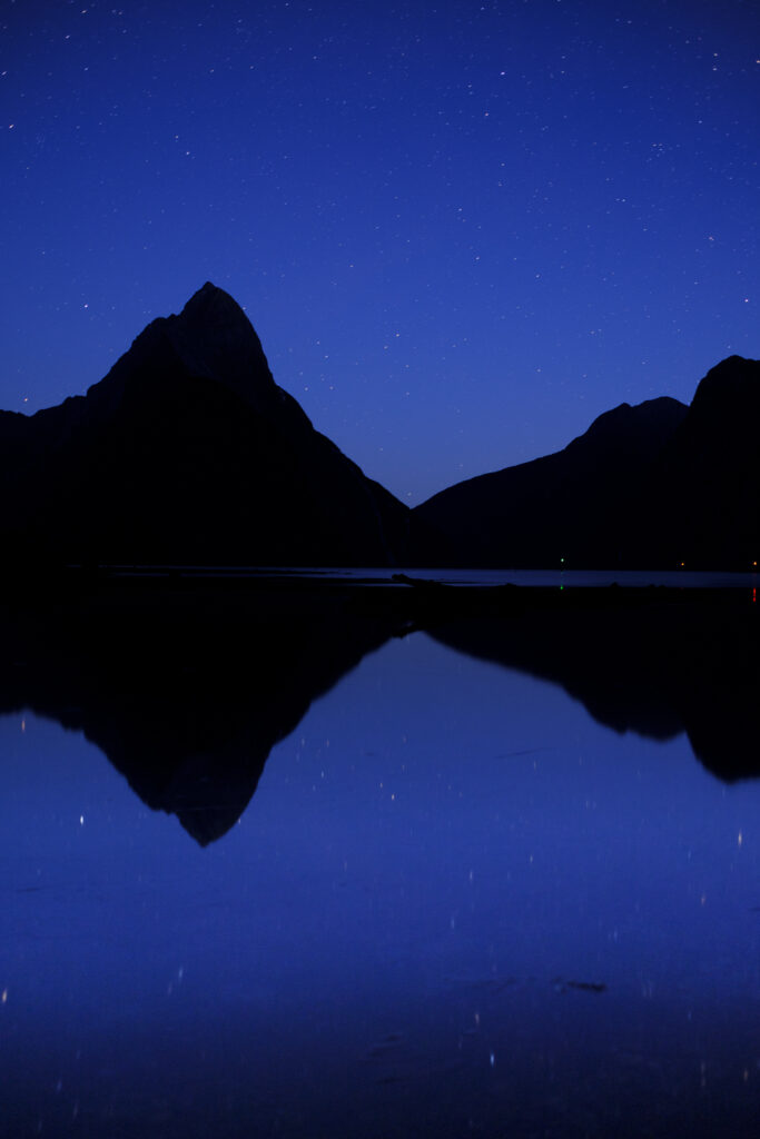 New Zealand, South Island, Fiordland National Park. The blue tones of pre-dawn at the Milford Sound.