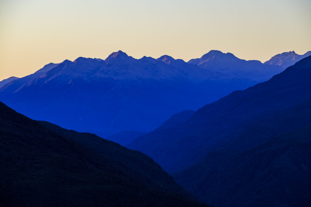 New Zealand, South Island, Fiordland National Park. Late afternoon light on the mountain peaks of the Fiordland National Park viewed from the Key Summit track.