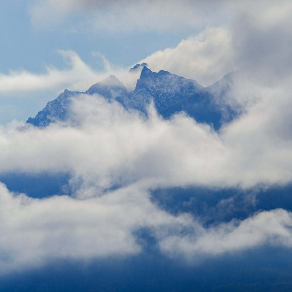 New Zealand, Otago, Lake Wakatipu. Morning mist clings to the mountains above Lake Wakatipu near the tourist hotspot of Queenstown.