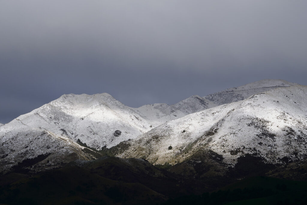New Zealand, South Island, Canterbury. Fresh snowfall as a storm engulfs the Lowry Peaks Mountain Range.