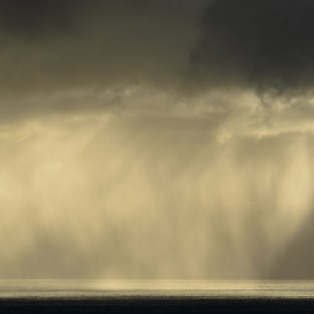 New Zealand, Westland, Haast. Sunburst over the wild, west coast of the New Zealand South Island.