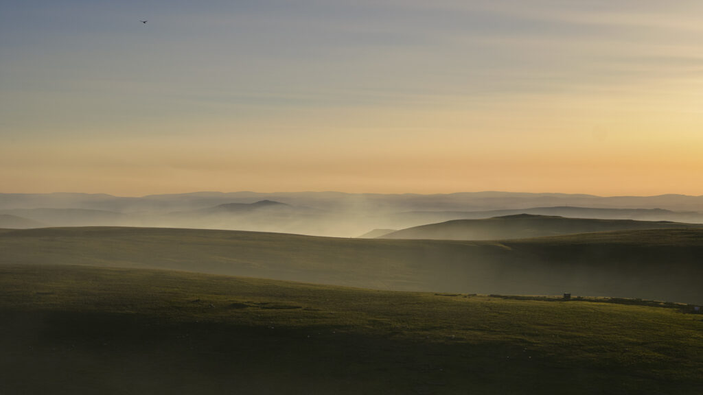 England, Northumberland, Northumberland National Park. Smoke from a nearby wild fire on the Otterburn Ranges engulfs the Cheviot Hills.