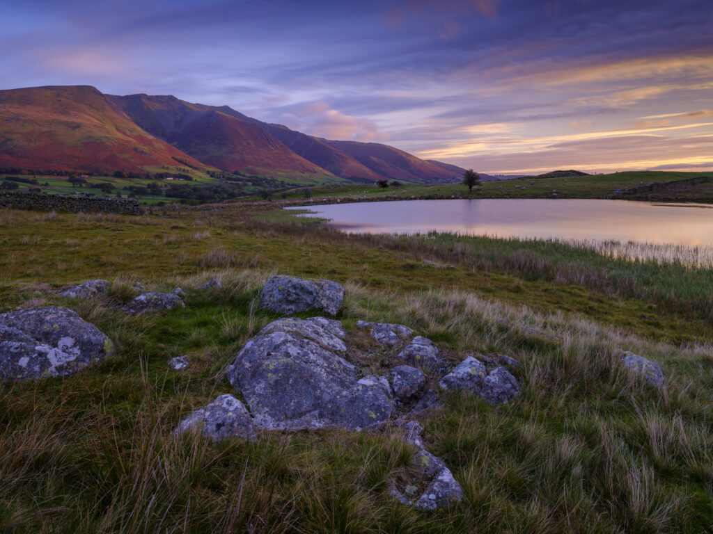 Tewit Tarn (also spelt as Tewet Tarn) viewed at dawn with Blencathra in the distance.