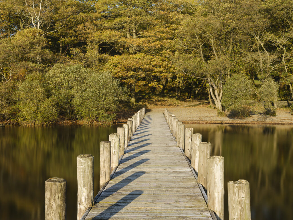 England, Cumbria, Lake District National Park. Coniston Water on a calm, autumn day.