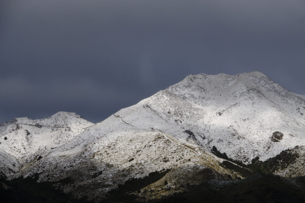 New Zealand, South Island, Canterbury. Fresh snowfall as a storm engulfs the Lowry Peaks Mountain Range.