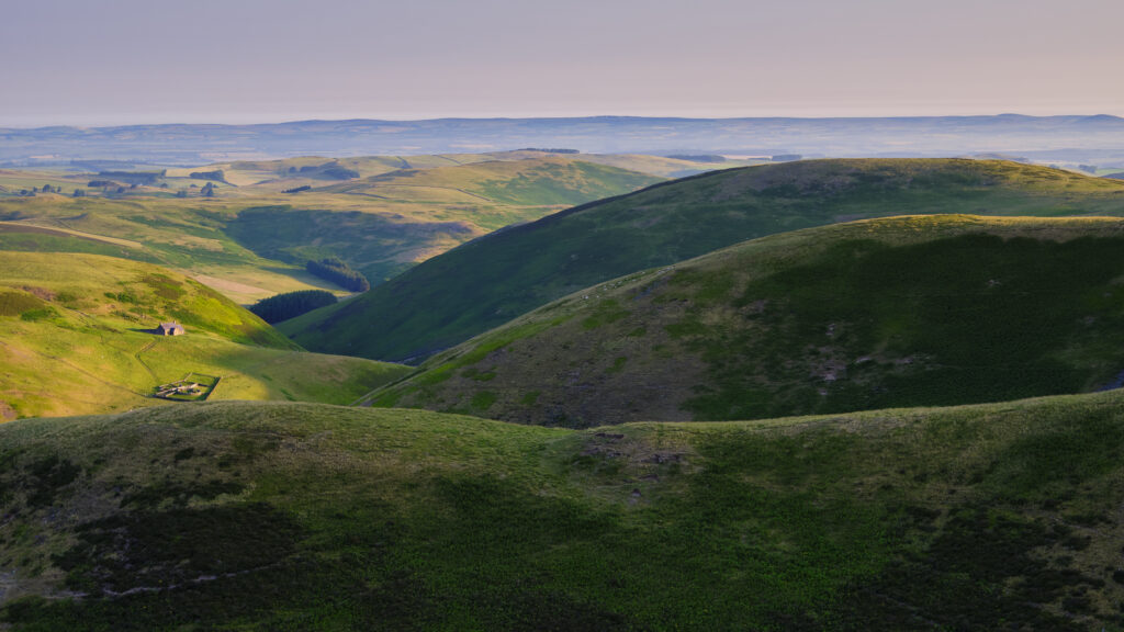 England, Northumberland, Northumberland National Park. Looking north from the Lamb Hill Mountain Refuge Hut at dawn, across the national park towards the Scottish Borders.