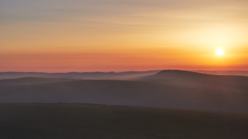 England, Northumberland, Northumberland National Park. Smoke from a nearby wild fire on the Otterburn Ranges engulfs the Cheviot Hills.