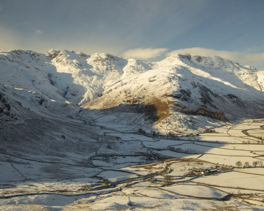 England, Cumbria, Lake District National Park. A snow covered Great Langdale Valley photographed on a mid winter day.