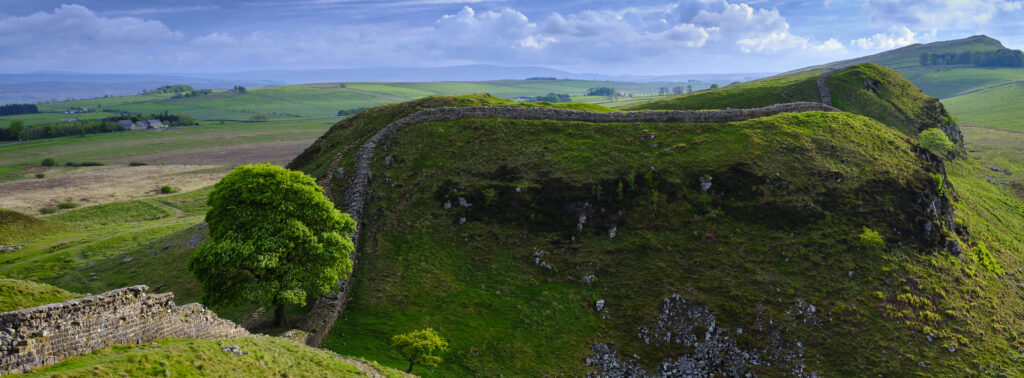 England, Northumberland, Northumberland National Park. Panoramic view of Sycamore Gap, a famous landmark along Hadrian's Wall.
