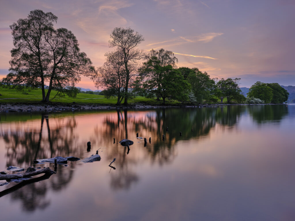 England, Cumbria, Lake District National Park. Sunset at Low Wray refelcted in the still waters of Lake Windermere near the town of Ambleside.