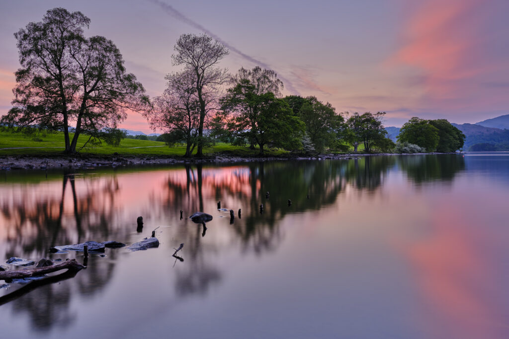 England, Cumbria, Lake District National Park. Sunset at Low Wray refelcted in the still waters of Lake Windermere near the town of Ambleside.
