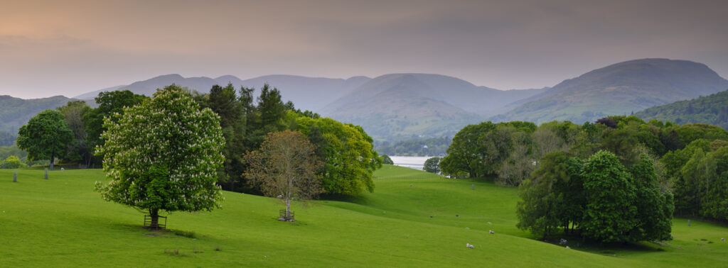 England, Cumbria, Lake District National Park. View from Wrey Castle looking over Low Wray and Lake Windermere towards the town of Ambleside.