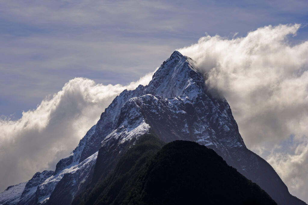 New Zealand, Southland, Fiordland National Park. A clearing storm behind Mitre peak, a famous landmark of the Milford Sound.