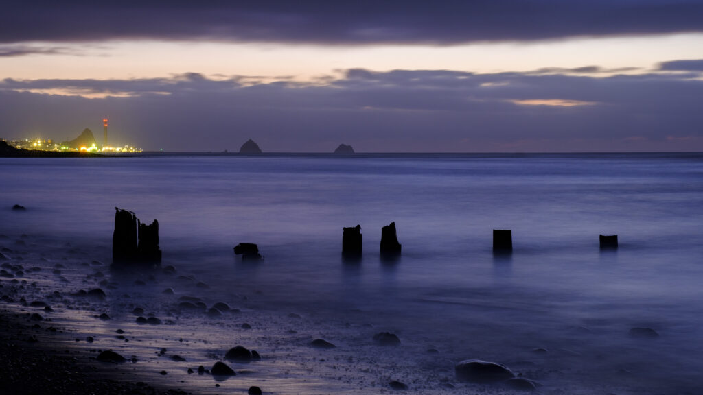 New Zealand, North Island, New Plymouth. Beach north of Fitzroy at dusk, on the Taranaki coast near New Plymouth.
