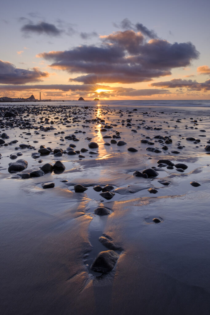 New Zealand, North Island, New Plymouth. Fitzroy Beach at sunset, a popular local beach near New Plymouth in the Taranaki region.