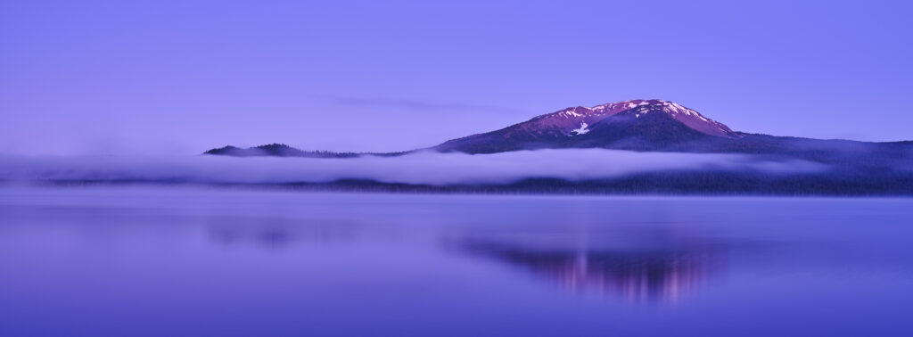 United States of America, Oregon, Diamond Lake. Dawn mist surrounds Mount Bailey and Diamond Lake in the Umpqua National Forest.