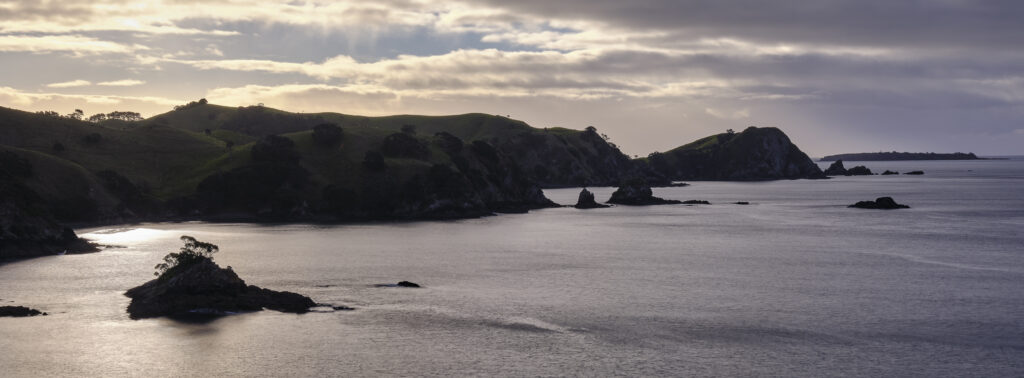 New Zealand, North Island, Matauri Bay. The picturesque Matauri Bay, near the Cavalli Islands - The final resting place of the Greenpeace Rainbow Warrior ship.