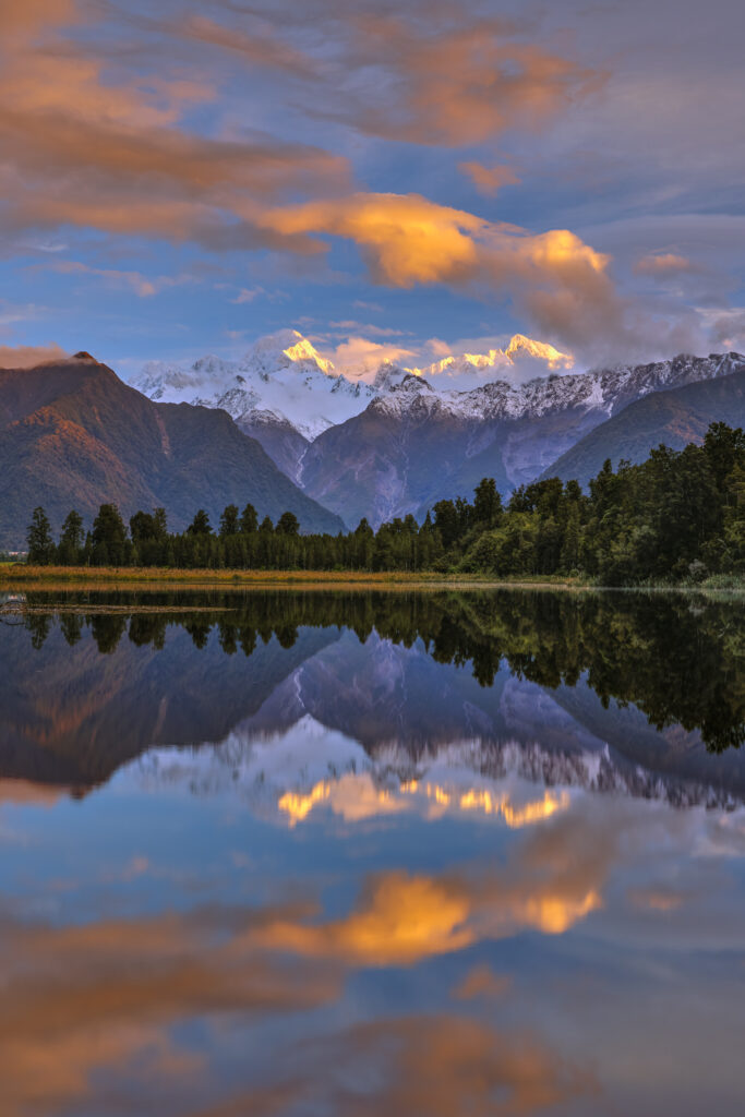 New Zealand, Westland, Westland National Park. Mt Cook and Mt Tasman reflected in the still waters of Lake Matheson.