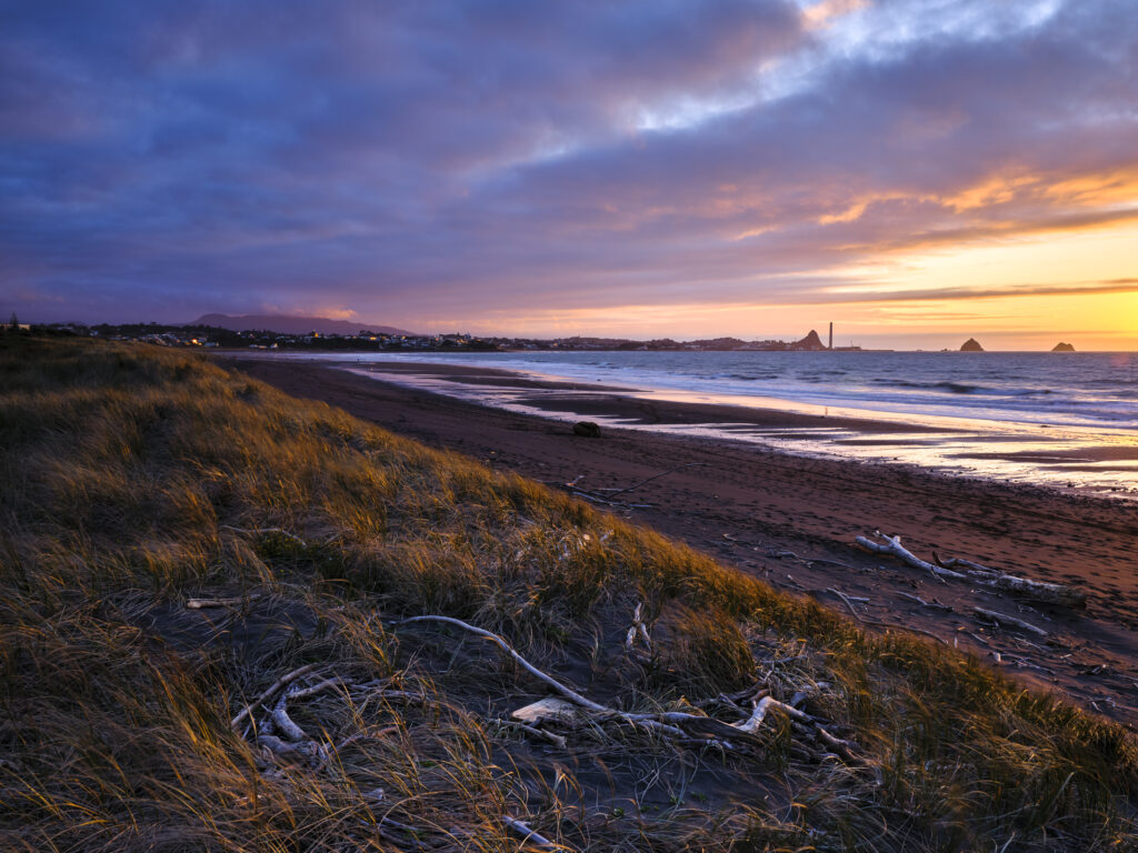 New Zealand, North Island, New Plymouth. Fitzroy Beach at sunset, a popular local beach near New Plymouth in the Taranaki region.