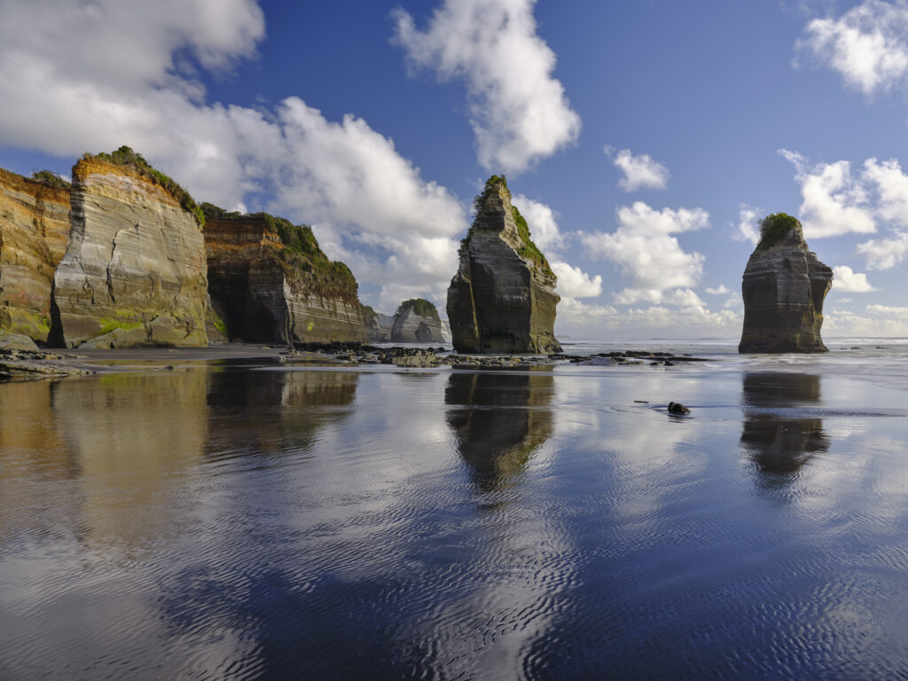 New Zealand, North Island, Three Sisters. The unique rock formations known as the Three Sisters and The Elephant, located on the North Taranaki Coast near Tongaporutu.