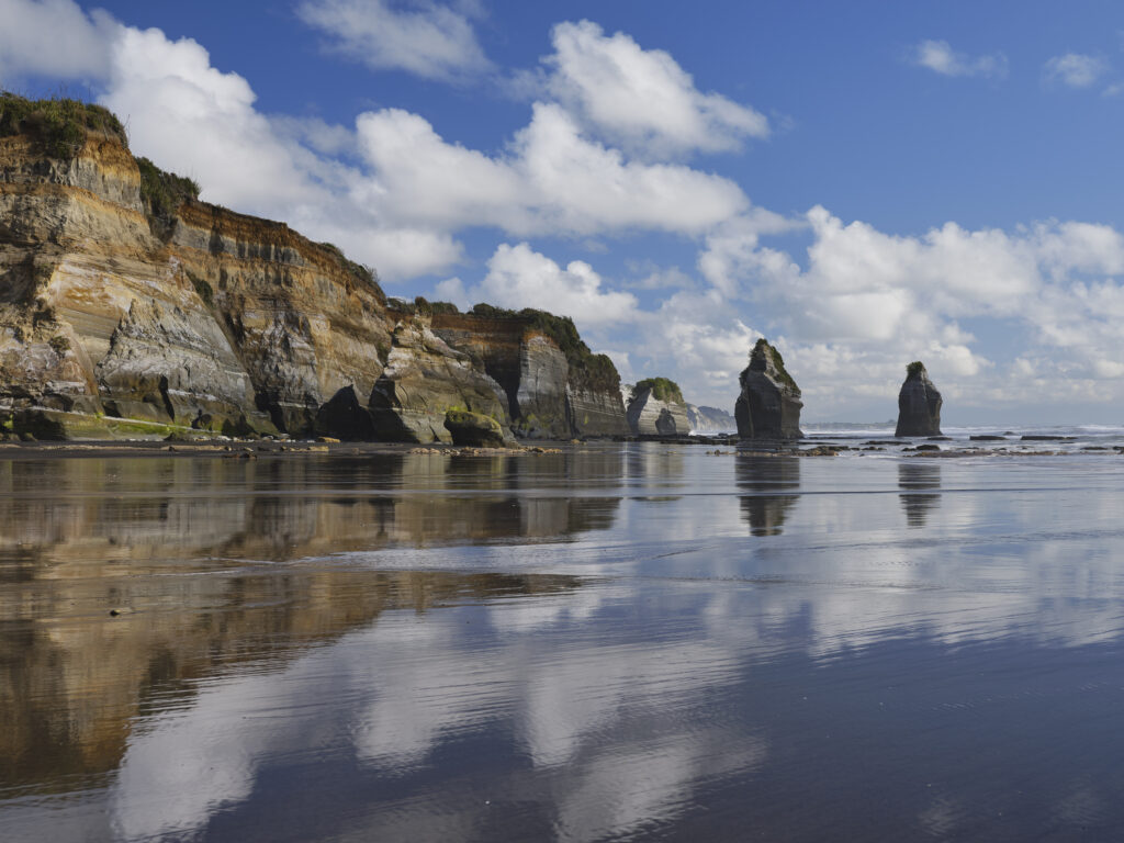 New Zealand, North Island, Three Sisters. The unique rock formations known as the Three Sisters and The Elephant, located on the North Taranaki Coast near Tongaporutu.