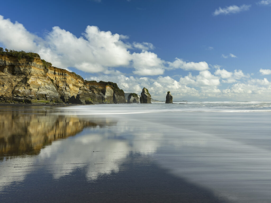 New Zealand, North Island, Three Sisters. The unique rock formations known as the Three Sisters and The Elephant, located on the North Taranaki Coast near Tongaporutu.