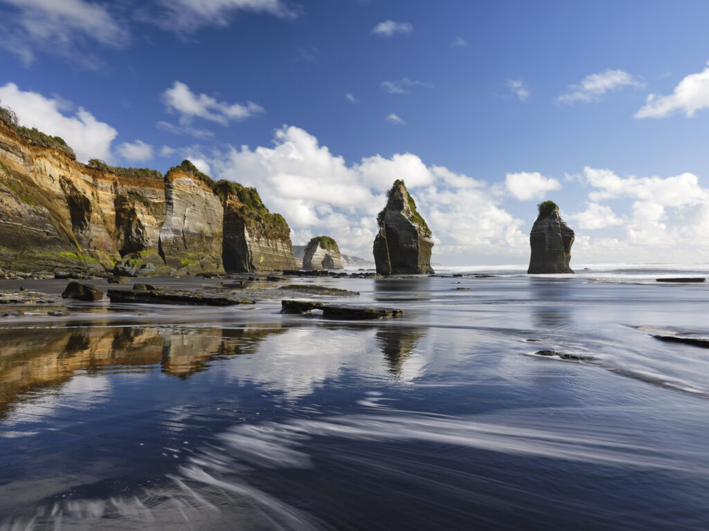 New Zealand, North Island, Three Sisters. The unique rock formations known as the Three Sisters and The Elephant, located on the North Taranaki Coast near Tongaporutu.