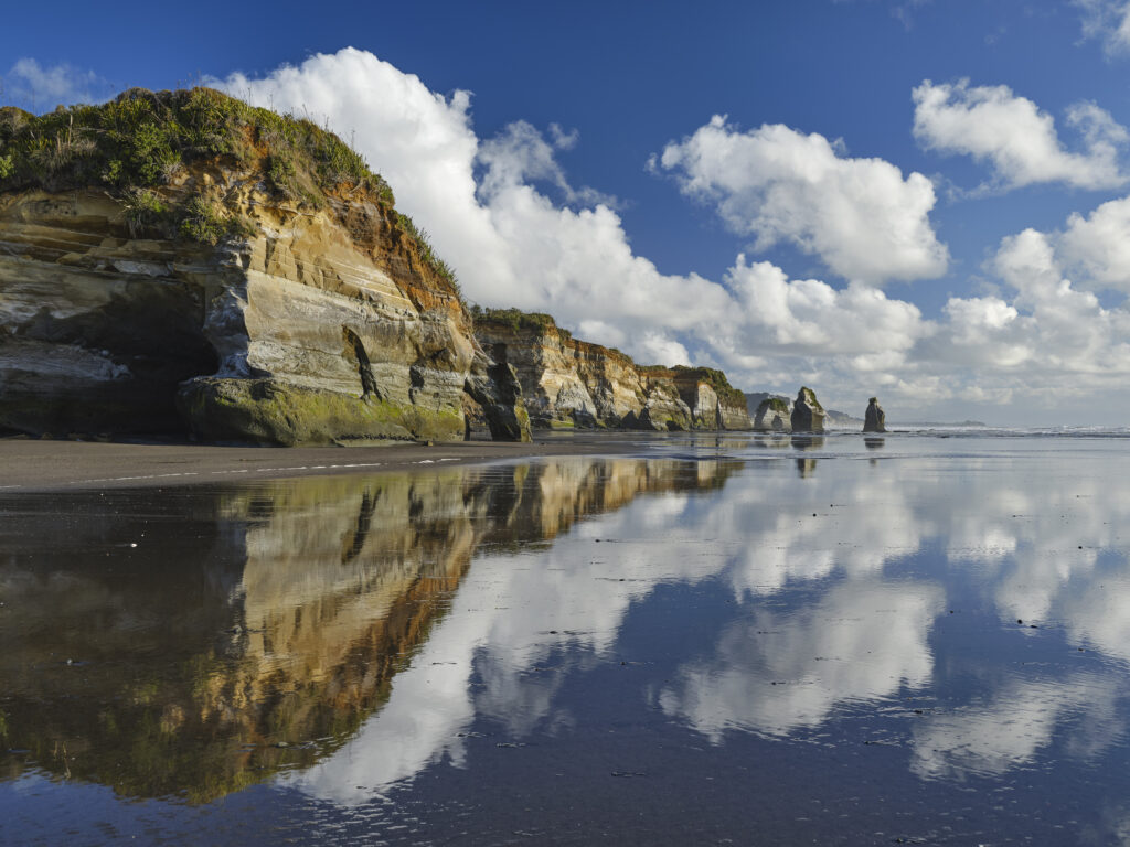 New Zealand, North Island, Three Sisters. The unique rock formations known as the Three Sisters and The Elephant, located on the North Taranaki Coast near Tongaporutu.