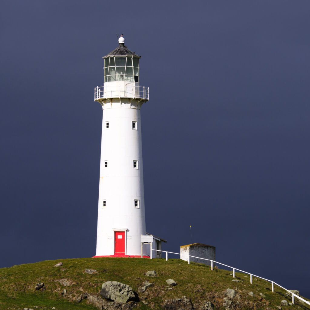 New Zealand, North Island, Cape Egmont Lighthouse. Cape Egmont Lighthouse has been shining its light along the Taranki coast (south of New Plymouth) since 1881.