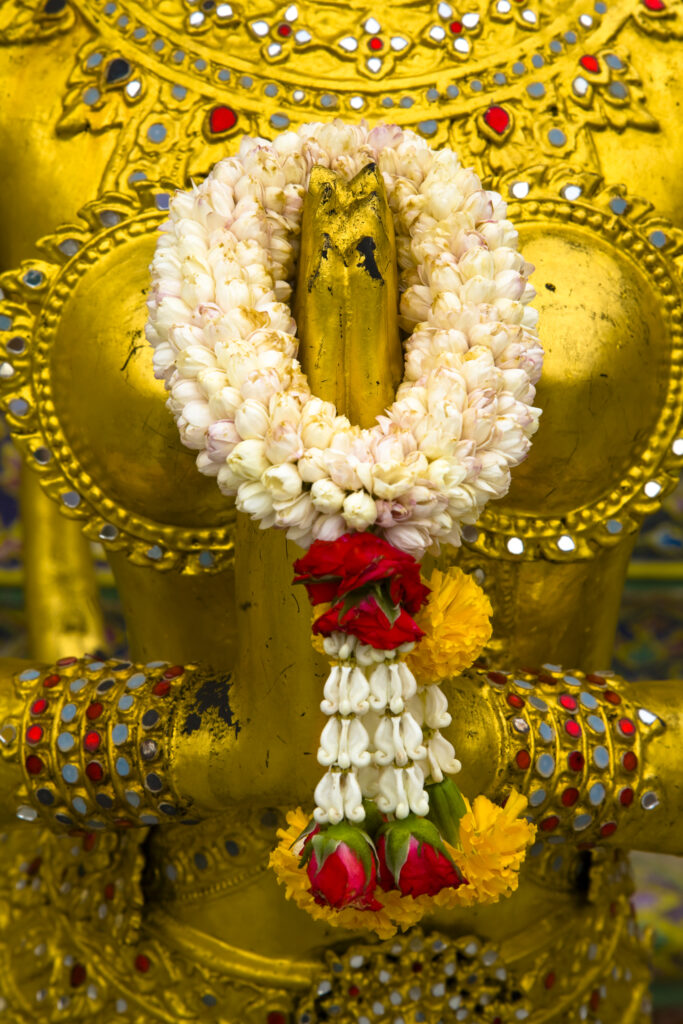 Thailand, Bangkok, The Grand Palace. Statue in the ornate setting of the golden grand palace.