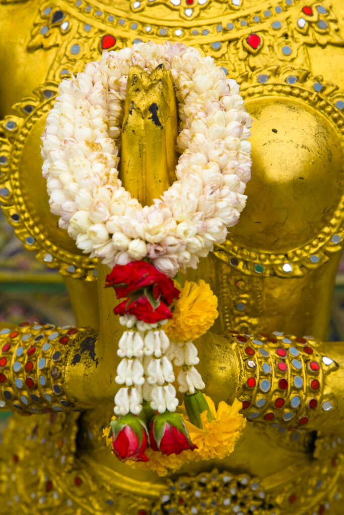 Thailand, Bangkok, The Grand Palace. Statue in the ornate setting of the golden grand palace.