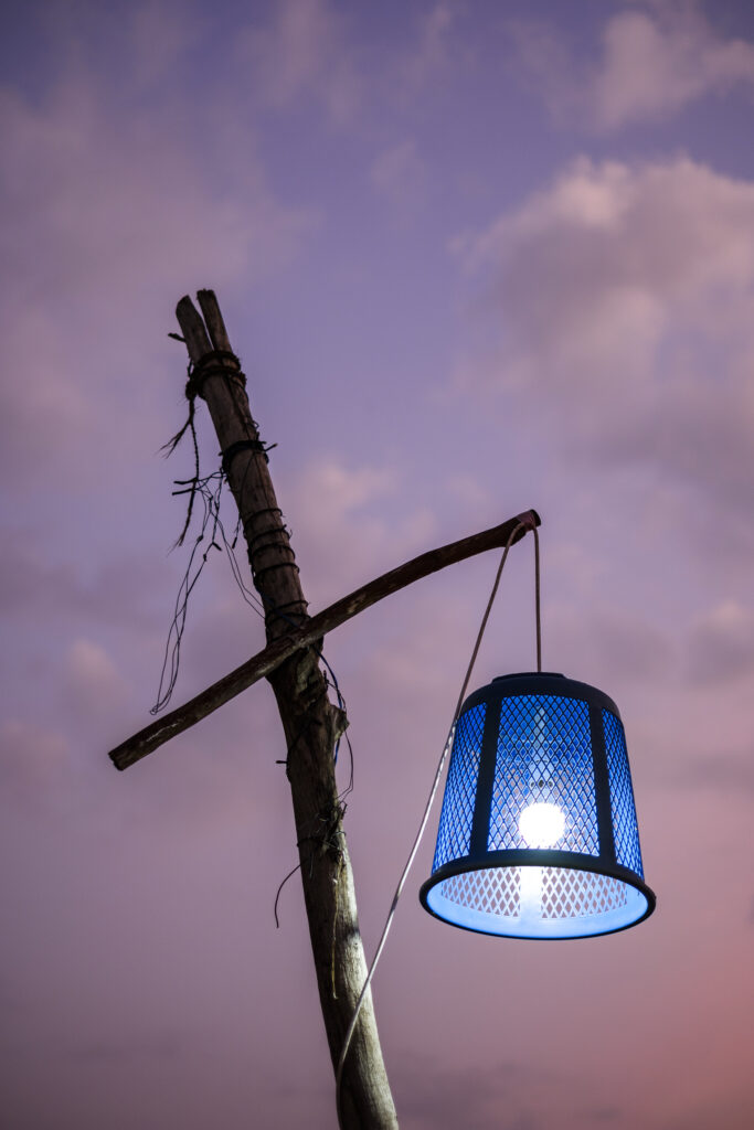 Sri Lanka, Galle District, Ahungalla. A colourful sunset behind a makeshift street lamp on Ahungalla beach.