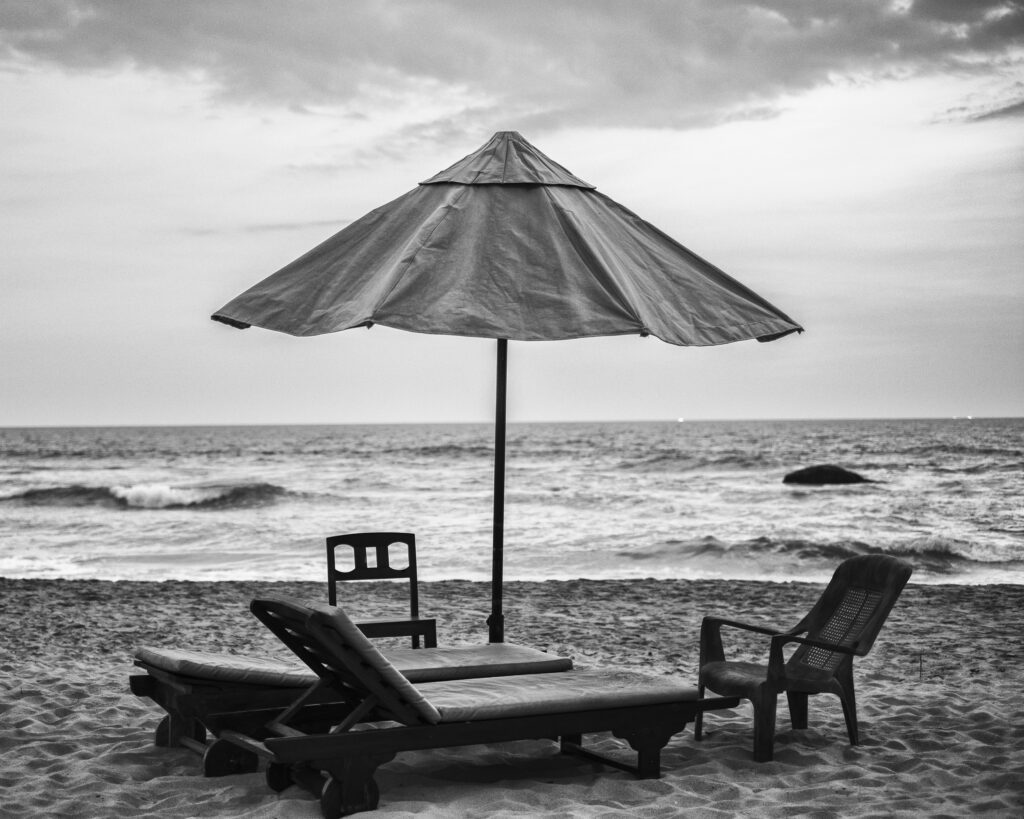 Sri Lanka, Galle District, Ahungalla. Lounger and parasol on Ahungalla beach.