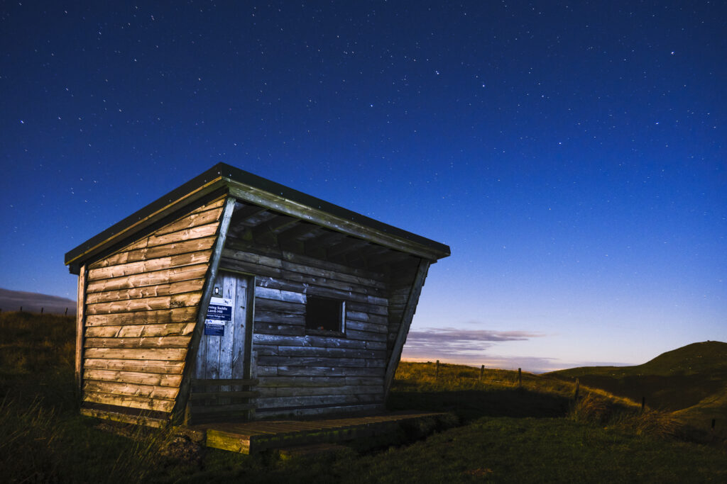 England, Northumberland, Northumberland National Park. Midnight at the Yearning Saddle / Lamb Hill Refuge Hut, located along the Pennine Way long distance track as it runs through the Cheviot Hills near the Scottish Border.