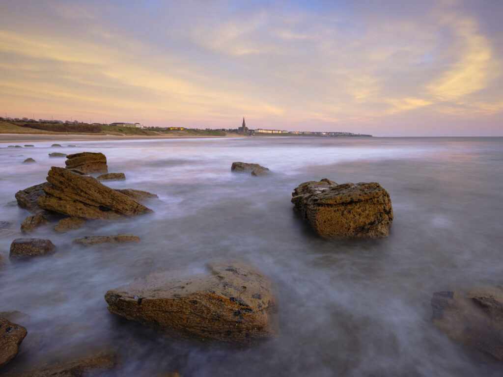 England, Tyne and Wear, Tynemouth. Looking north from Sharpness Point towards Cullercoats and Tynemouth Long Sands.