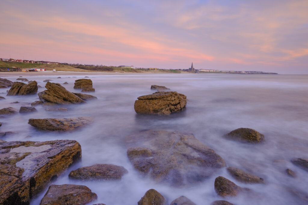 England, Tyne and Wear, Tynemouth. Looking north from Sharpness Point towards Cullercoats and Tynemouth Long Sands.
