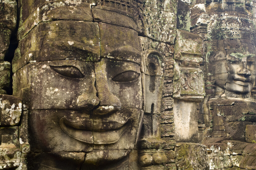 Cambodia, Angkor Thom, Bayon. Massive stone faces watch your every move at Bayon, a well-known and richly decorated Khmer temple at Angkor in Cambodia.