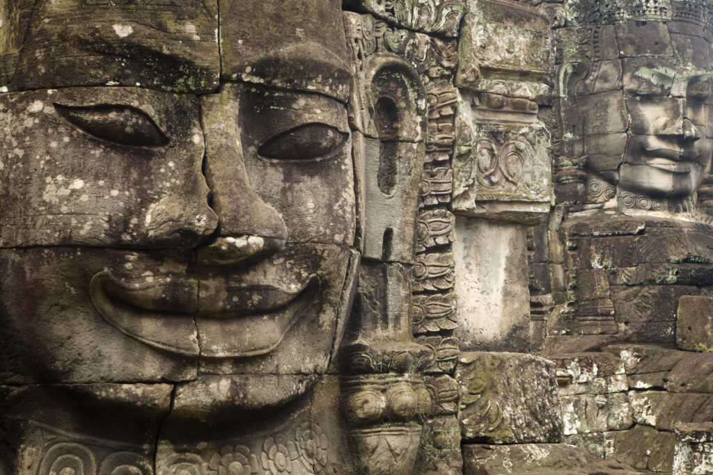 Cambodia, Angkor Thom, Bayon. Massive stone faces watch your every move at Bayon, a well-known and richly decorated Khmer temple at Angkor in Cambodia.