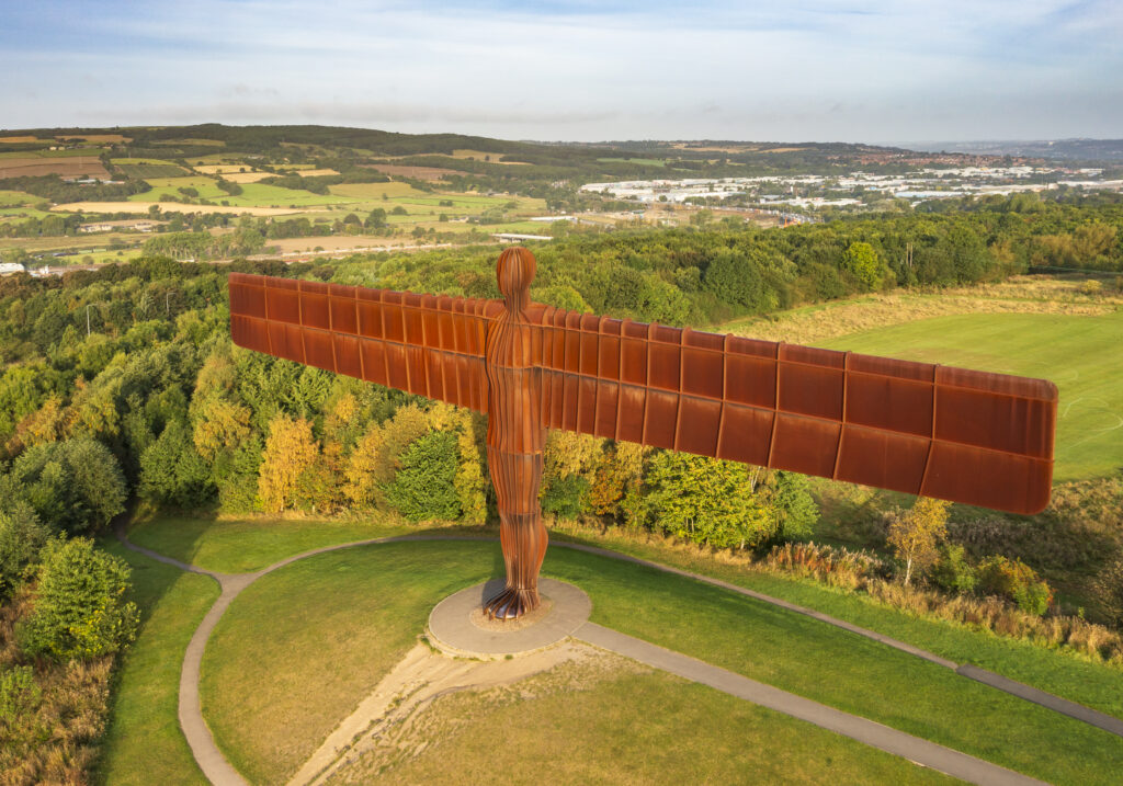 England, Tyne and Wear, Gateshead. Aerial (drone) view of the iconic Angel of the North statue by Antony Gormley. The 'Angel', built on a a former colliery pit head bath site, is one of the worlds most viewed work of art with over 33 million viewers each year.