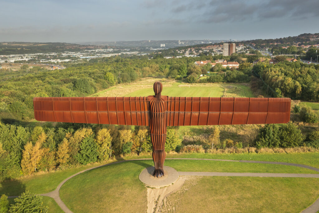 England, Tyne and Wear, Gateshead. Aerial (drone) view of the iconic Angel of the North statue by Antony Gormley. The 'Angel', built on a a former colliery pit head bath site, is one of the worlds most viewed work of art with over 33 million viewers each year.