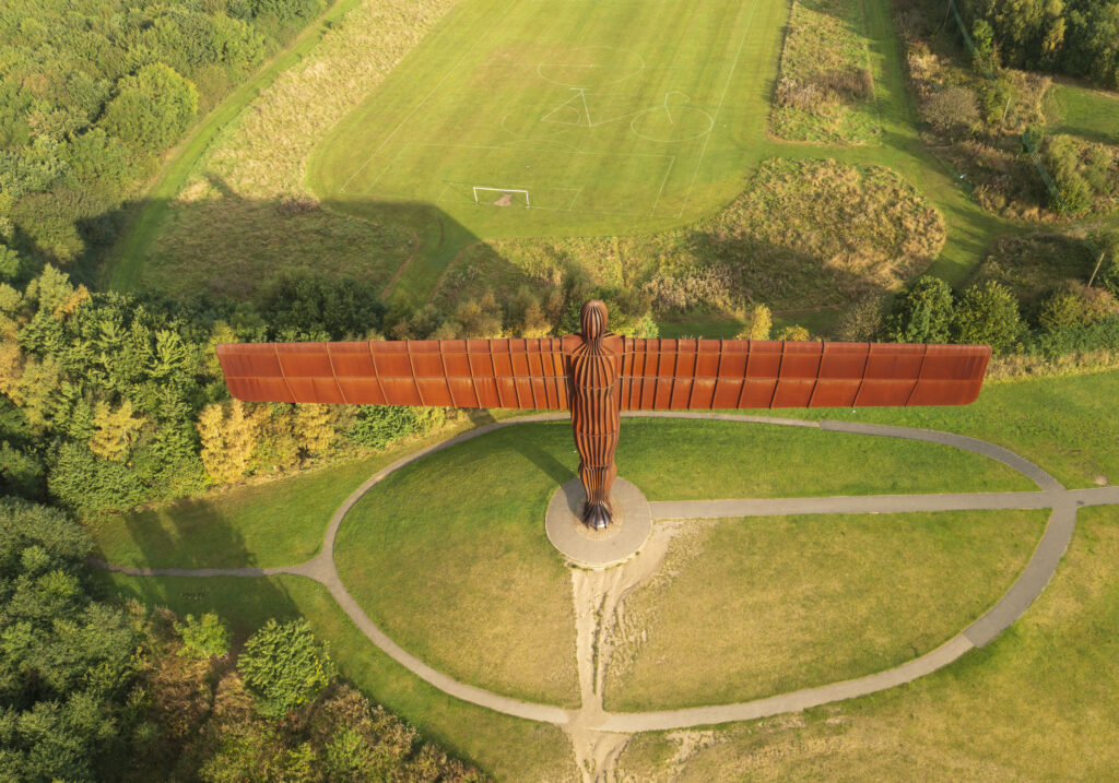England, Tyne and Wear, Gateshead. Aerial (drone) view of the iconic Angel of the North statue by Antony Gormley. The 'Angel', built on a a former colliery pit head bath site, is one of the worlds most viewed work of art with over 33 million viewers each year.