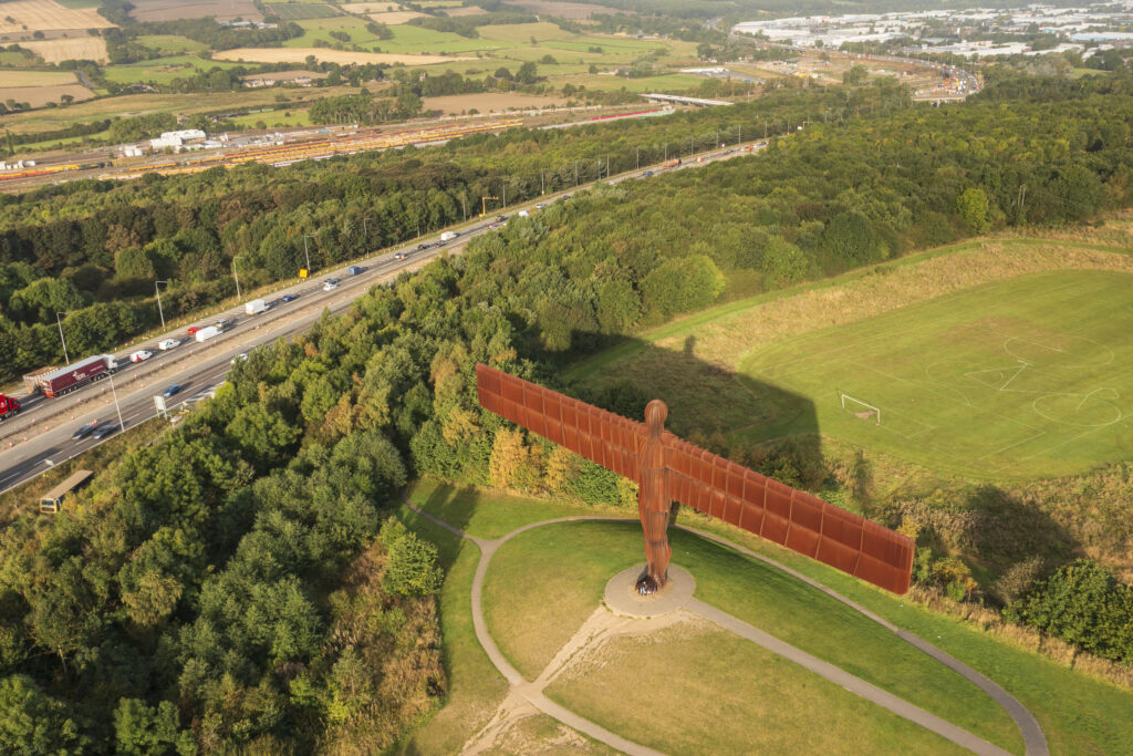 England, Tyne and Wear, Gateshead. Aerial (drone) view of the iconic Angel of the North statue by Antony Gormley. The 'Angel', built on a a former colliery pit head bath site, is one of the worlds most viewed work of art with over 33 million viewers each year.