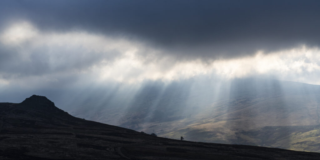 England, Northumberland National Park, Harthope Valley. Breaking light above the Cheviot Hills in the Harthope Valley.