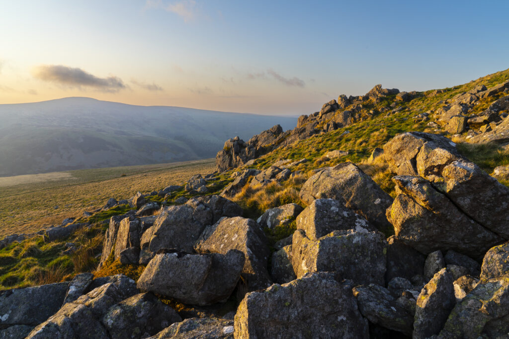 England, Northumberland National Park, Harthope Valley. Sunset at Langlee Crags located above the Harthope Valley.