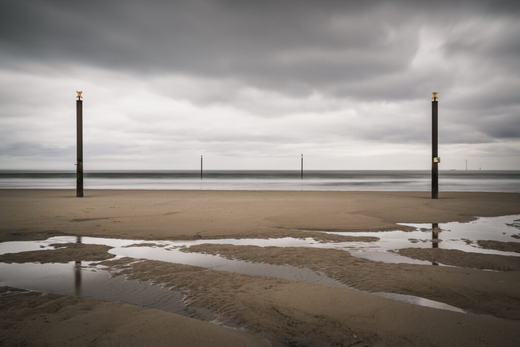 England, Northumberland, Cambois. Marker posts in the north sea near Blyth.