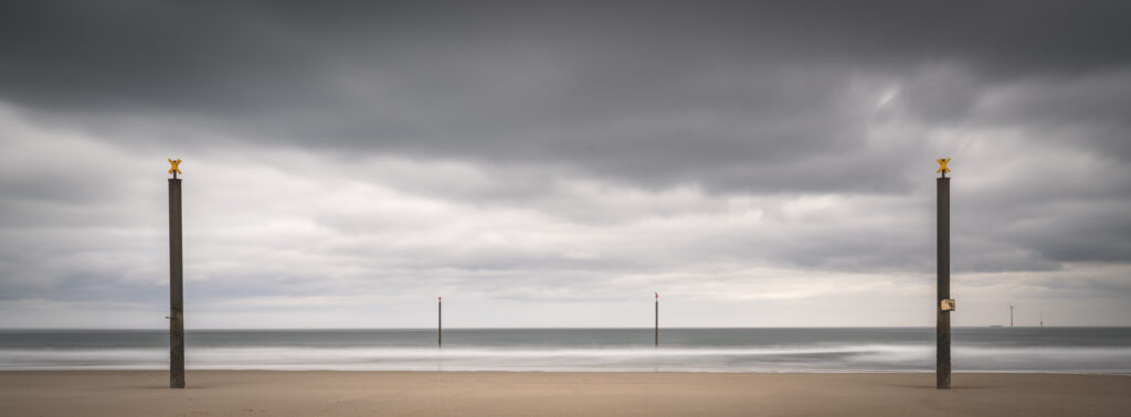 England, Northumberland, Cambois. Marker posts in the north sea near Blyth.